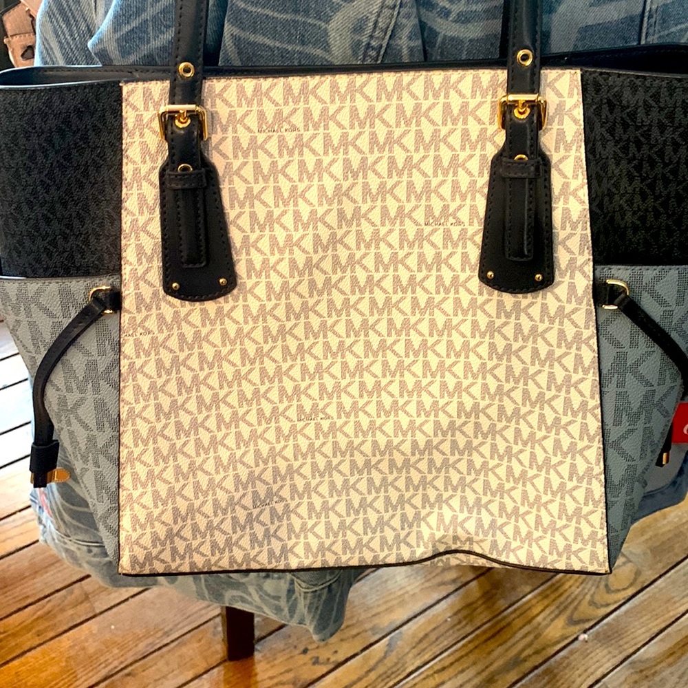 Michael Kors.  Minimal use.  Still factory stiff.